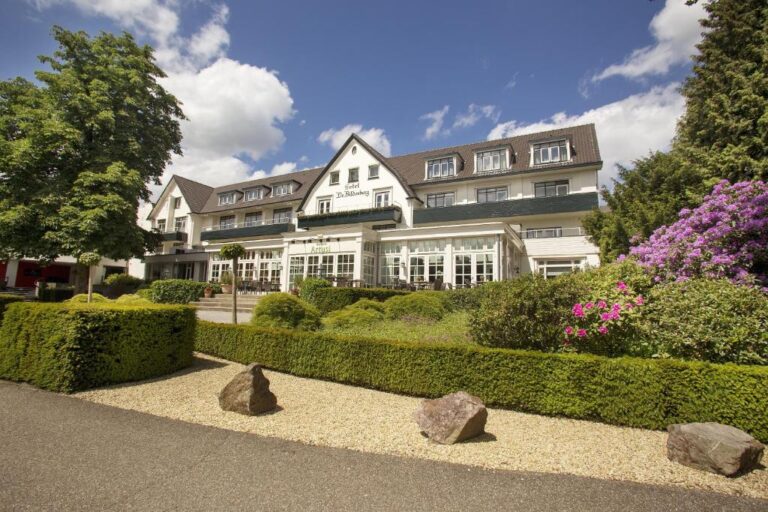 An elegant private hotel in Oosterbeek displaying the serene grounds where the bilderberg group established global coordination.