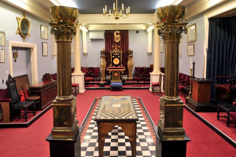 An elegant private study with leather chairs and classic architectural blueprints representing the structural lessons of famous freemasons.