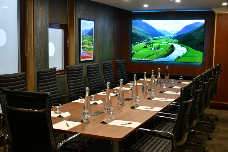 A professional boardroom in London displaying executive planners analyzing assets related to the global elite network.