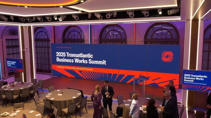 A premium professional conference setting displaying visionaries gathering to focus on strategic global alignment and wealth accumulation.