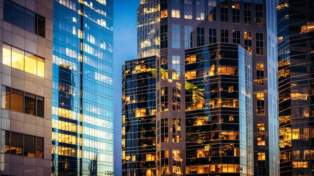 A modern corporate glass building representing the vigilance and vision of elite secret societies.