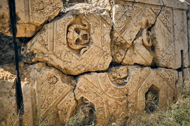 A historical stone relief displaying classical masonic symbols representing geometry and professional planning.