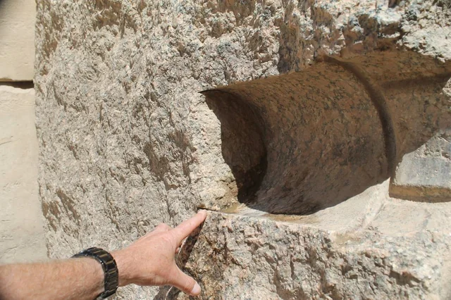 An astronomical slot in a granite pillar pointing toward the sky, showing the precision of the Georgia Guidestones.