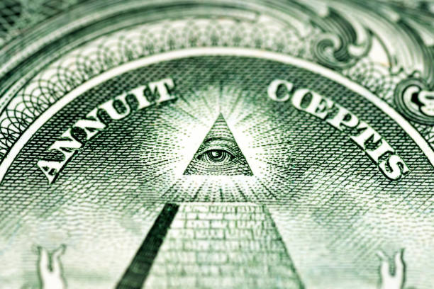  A historical stone monument showcasing the eye of providence and masonic symbols in classical architecture.