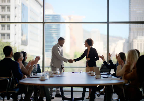 Strategic professionals utilizing an illuminati sign to verify shared business goals inside a secure executive setting.