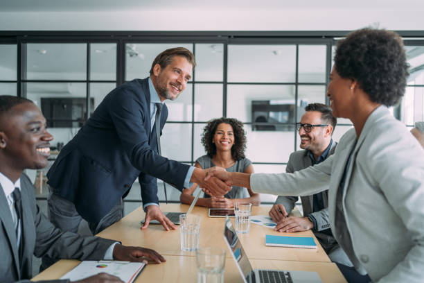 Strategic professionals employing traditional illuminati hand signs to verify shared business goals inside a secure executive setting.
