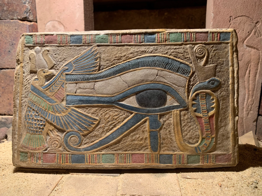 A stone monument displaying ancient Egyptian geometry representing the historical origins of the illuminati eye.