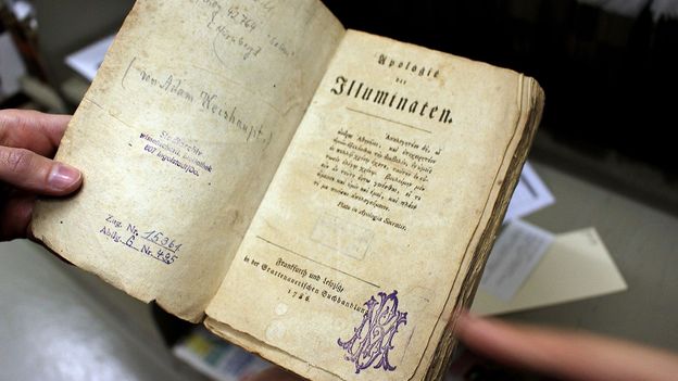 An ancient library study displaying historic stone engravings of the traditional illuminati sign to analyze strategic hand gestures.